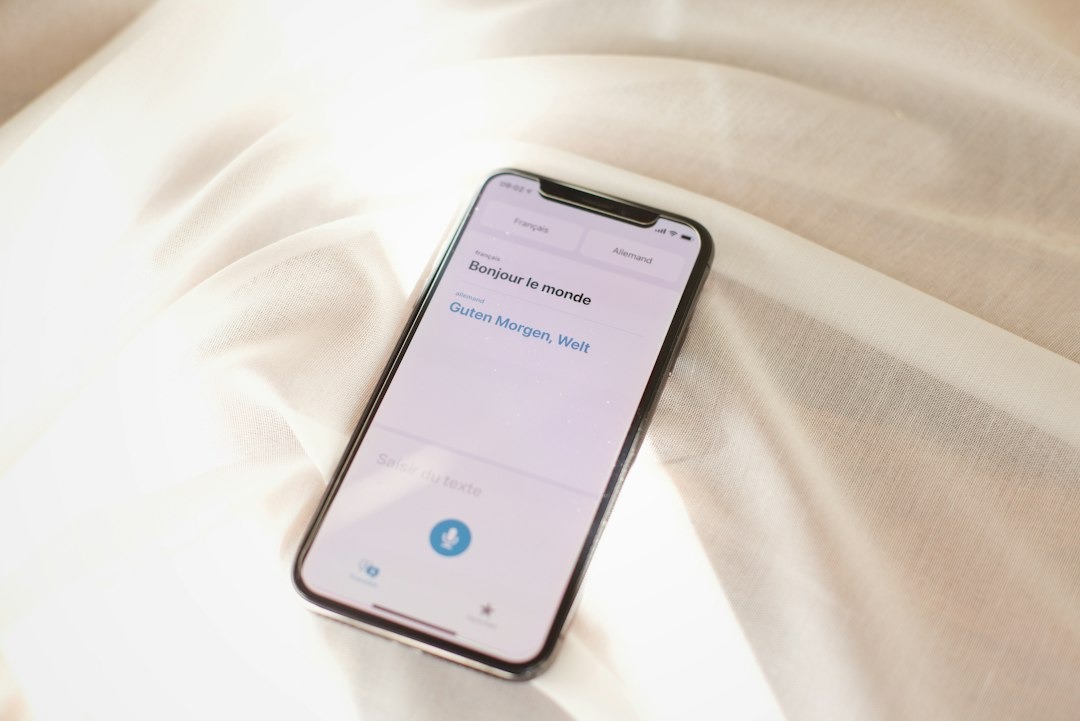 Smartphone displaying language translation app on fabric.
